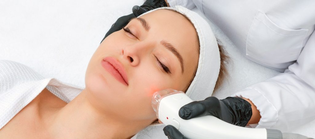 woman getting fraxel laser treatment on face