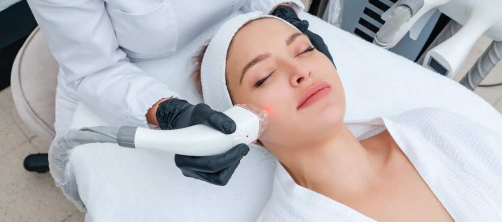 woman getting fraxel laser therapy on face